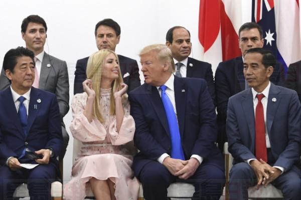 epa07681644 US President Donald Trump (C, right) speaks to his daughter and Adviser to US President Ivanka Trump (C, left) during the Leader s Special event on Women s Empowerment during the second day of the G20 summit in Osaka, Japan, 29 June 2019. It is the first time Japan will host a summit. The summit gathers leaders from 19 countries and the European Union to discuss topics such as global economy, trade and investment, innovation and employment.  EPA-EFE/LUKAS COCH  AUSTRALIA AND NEW ZEALAND OUT