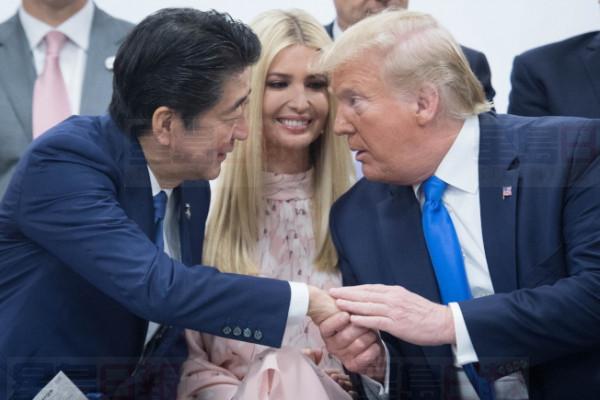 epa07681917 US President Donald J. Trump (R) shakes hands with Japanese Prime Minister Shinzo Abe (L) as Ivanka Trump (C) looks on during a meeting of G20 leaders to discuss empowering women around the world during the second day of the G20 summit in Osaka, Japan, 29 June 2019. It is the first time that Japan hosts a G20 summit. The summit gathers leaders from 19 countries and the European Union to discuss topics such as global economy, trade and investment, innovation and employment.  EPA-EFE/Stefan Rousseau / POOL