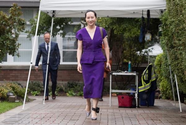 Huawei chief financial officer Meng Wanzhou, who is out on bail and remains under partial house arrest after she was detained last year at the behest of American authorities, wears an electronic monitoring bracelet on her ankle as she leaves her home to attend a court hearing in Vancouver, on Monday September 23, 2019. THE CANADIAN PRESS/Darryl Dyck